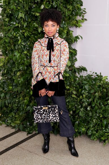 Logan Browning wearing Fall Winter 2019 Pleated Ruffle Blouse, Cropped Flare Jeans, Pearl Charm Heart Earring, Lee Radziwill Small Bag and Lila Knee Boot